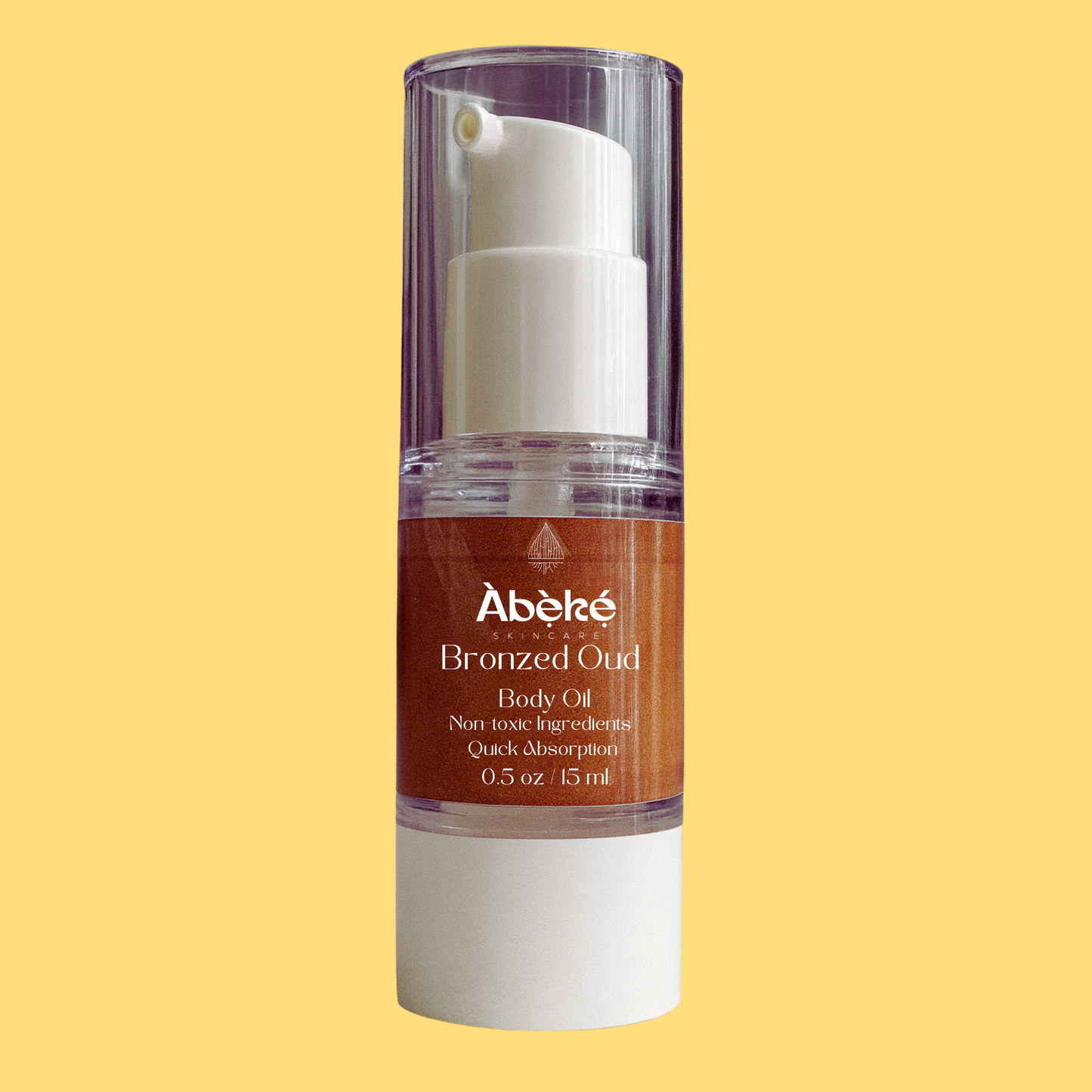 A bottle of Abeke Bronzed Oud body oil on a yellow background