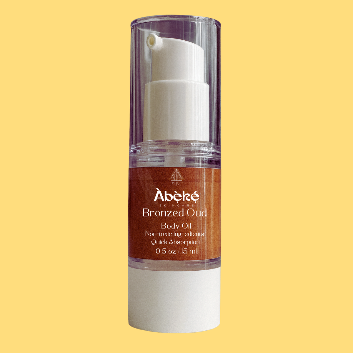 A bottle of Abeke Bronzed Oud body oil on a yellow background