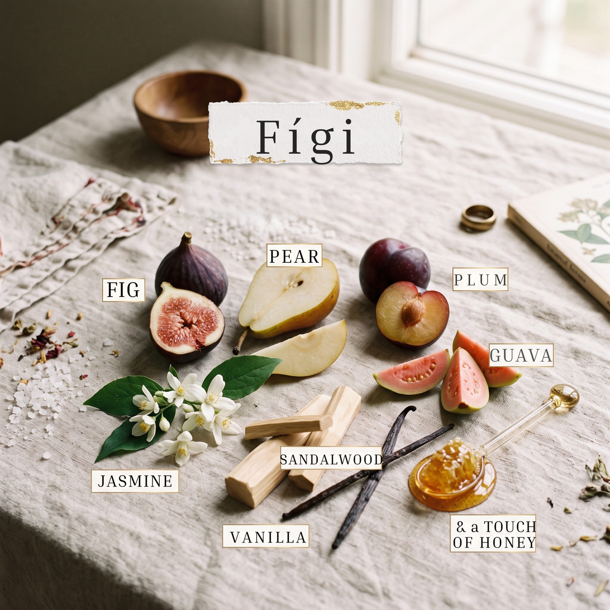 A styled flat-lay of natural fragrance ingredients labeled in Spanish on a linen table surface: figs, pear, plum, guava, jasmine blossoms, sandalwood, vanilla, and honey. A torn-paper label at the top reads “Fígi.